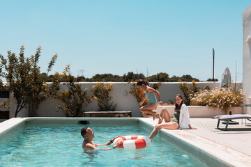 Family enjoying summer vacation playing in swimming pool © PintoArt