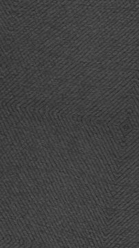 Closeup of gray fabric with subtle herringbone pattern suitable for background or textile design projects.
