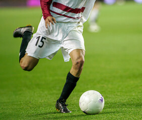 Close-up Footballer Dribbling Ball Dynamic Action Sports Field