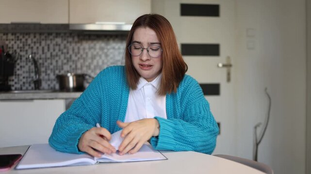 Young woman tears handwritten letter during psychological practice unable to hold emotions deep pain anger resentment and tears from past trauma emotional release