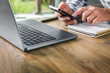 Man work home using smartphone and laptop