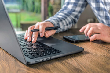 Man works at home online using laptop