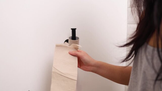 Asian woman holding toilet paper roll while sitting on toilet bowl. digestion, constipation, Diarrhea from food poisoning, infection, abdominal, stomachache, cystitis, Insurance, Health care and Medic