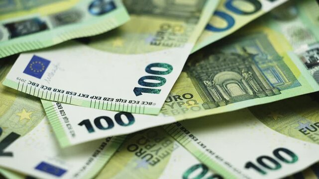 Close-up money texture made of numerous 100 euro banknotes, showing cash value, financial growth and investment security.