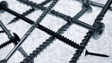 Pile of screws and nails of various sizes and shapes. Concept for renovation and construction.