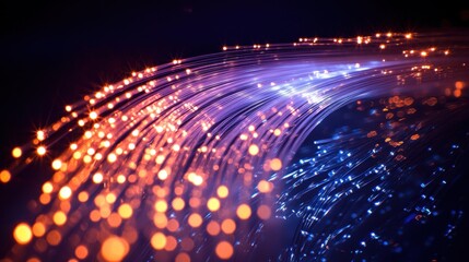 Fototapeta premium Macro light paths through luminous fiber optic strands creating cascading light trails with orange and blue cores flowing across dark background
