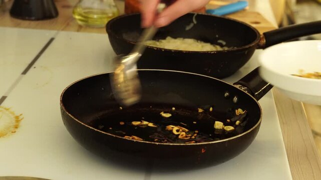 Woman is peeling and cutting garlic for cooking
