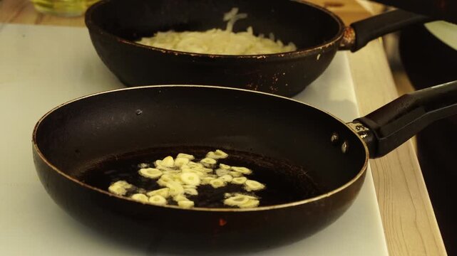 Woman is peeling and cutting garlic for cooking
