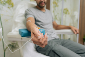 Patient receiving intravenous infusion treatment through iv drip on their arm, focusing on healthcare, medicine, medical therapy, and vitamin benefits in clinic setting. Concept of healthy lifestyle.