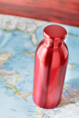 Red water bottle and paper map