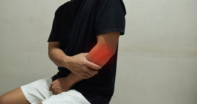 Man suffering from pain in cubit, disease of the elbow joint, bone fracture and inflammation. Health problems concept