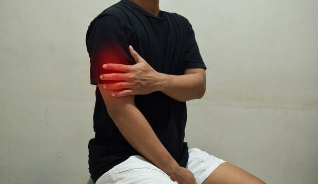 Man with pain in his arm Dislocation of the shoulder, joint inflammation, arthritis and degenerative changes. Health problems concept