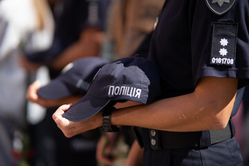 Ukrainian police officers in uniform with "Police" inscriptions paying tribute to fallen colleagues killed in the war, mourning and commemoration ceremony.