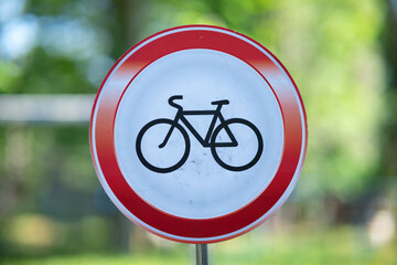 Prohibitory road sign "No cycling" with a bicycle silhouette inside a red circle, no bikes allowed traffic sign.