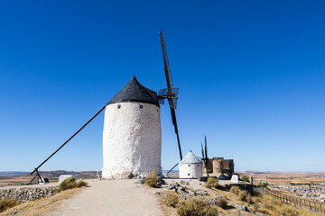 White windmills standing on hill in Consuegra Spain