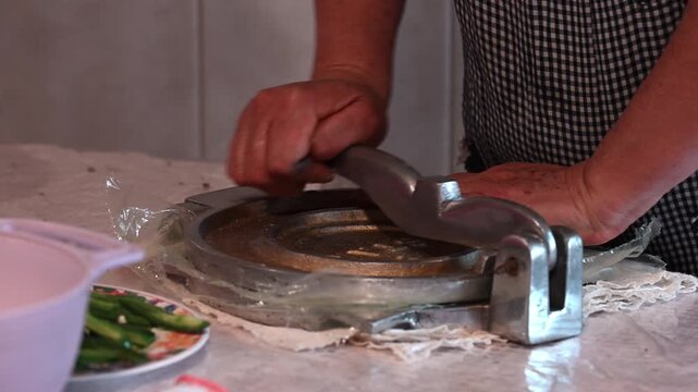 Process of making Mexican tortillas with a manual press