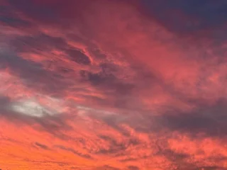 Selbstklebende Fototapeten Hochrot Dramatic sunset sky over rocky landscape. Sunset over rolling hills.  © NATALYA