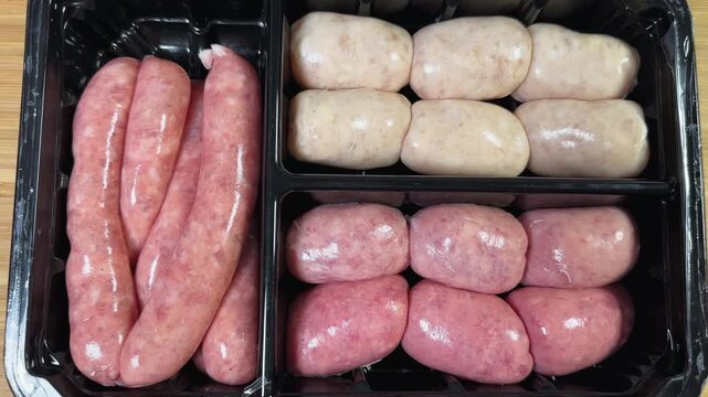 Set of the different raw sausages in plastic food packaging