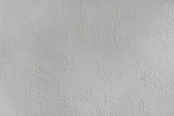 Fototapeta premium Close up of a white or light grey stucco wall with patches of textures. For a blank background use
