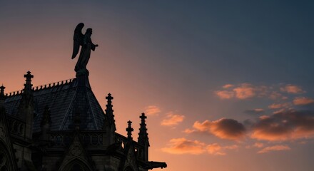 Fototapeta premium Silhouette of angel sculpture on gothic church rooftop. Religious art against an expressive sunset sky for spiritual or architectural design.