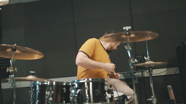 Professional musician drumming rhythm on drum kit