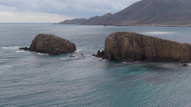Del Penon Blanco beach, Nijar: Dramatic rock formations emerging from the turquoise waters of the Mediterranean Sea in Andalusia