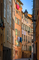 Fototapeta premium Colorful traditional houses line a narrow street in the Old Town of Nice, France