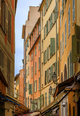 Obraz premium Colorful traditional houses line a narrow street in the Old Town of Nice, France
