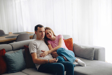 Obraz premium Couple spends time together on a couch while relaxing in their home during morning hours