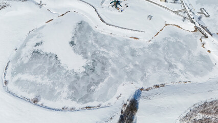 pond lake frozen snow covered water ice background from the air aerial 