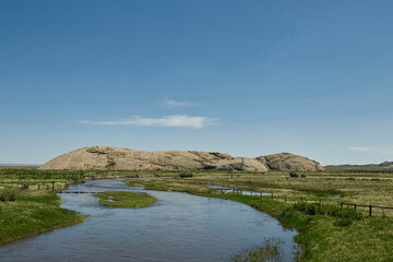 Granite Rock Outcrop Rising Beside a Winding River