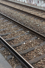 Close-up of railway tracks with gravel ballast, representing transportation infrastructure and travel.