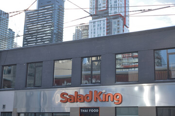 Naklejka premium exterior of Salad King, a Thai restaurant, located at 224 Queen St W, Toronto