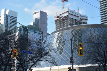Naklejka premium Roy Thomson hall, a concert venue, designed by Arthur Erickson, 1982, with FORMA Condos under construction, looking northwest on Simcoe St, Toronto