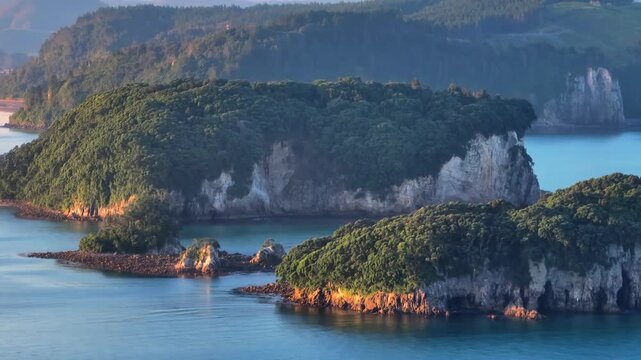 Scenic view of Clark Island, Whangamata, Coromandel Peninsula, New Zealand. showcasing the harbor and lush green hills.