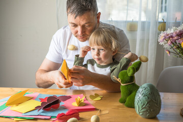 Obraz premium Father and 3-Year-Old Son Making a DIY Easter Bunny Together at Home