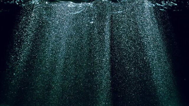 Dark Blue Ocean Surface Seen from Underwater , Super Slow Motion . Abstract Waves and Rays of Sunlight Shining Through