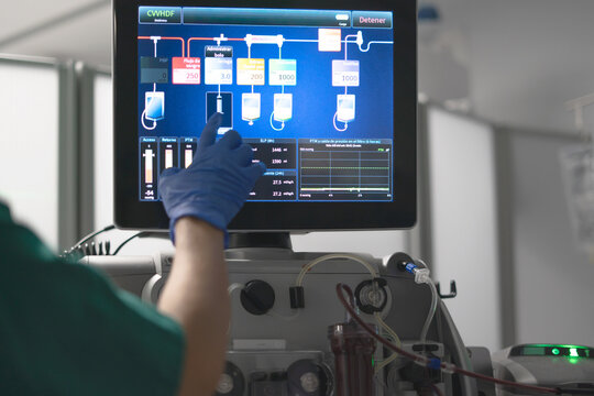 Medical professional operating dialysis machine in hospital