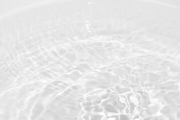 Obraz premium Blue water with ripples on the surface. Defocus blurred transparent blue colored clear calm water surface texture with splashes and bubbles. Water waves with shining pattern texture background.