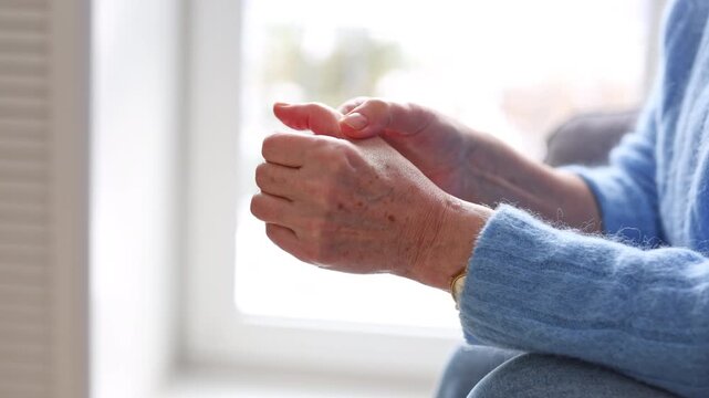 Senior woman suffering from pain in her hand
