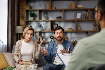 A visit to a family psychologist for a married couple. An African-American psychologist doctor...