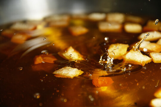 Frying stale bread in hot cooking oil