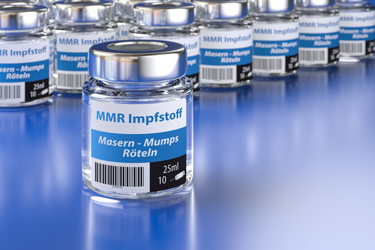 Vials of a fictitious MMR (Measles, Mumps, Rubella) vaccine with German language label (Masern, Mumps, R&ouml;teln). Large group of vials with one standing in front, selective focus on foreground