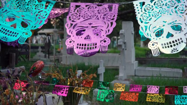 Traditional Mexican papel picado used in cemetery celebrations