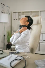 Fotobehang Onderzeeër Exhausted doctor suffering from neck and shoulder pain  © Miljan Živković