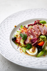 Gourmet salad with seared tuna and fresh vegetables
Fresh tuna steak salad served with mixed greens and eggs
Elegant restaurant salad with grilled tuna and olives
