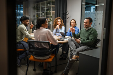 Diverse business team collaborating in a modern office meeting