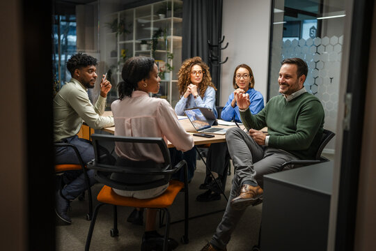 Diverse business team collaborating in a modern office meeting