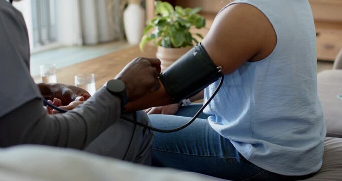 Manual pump is being squeezed, cuff is tightening on arm for measuring blood pressure at home