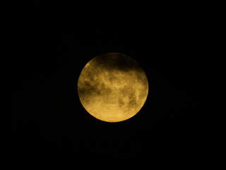 Fototapeta premium Tokyo,Japan - February 2,2026: The full moon covered with Moving clouds at dawn